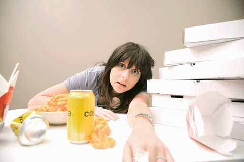 WomanSurroundedByUnhealthyFood