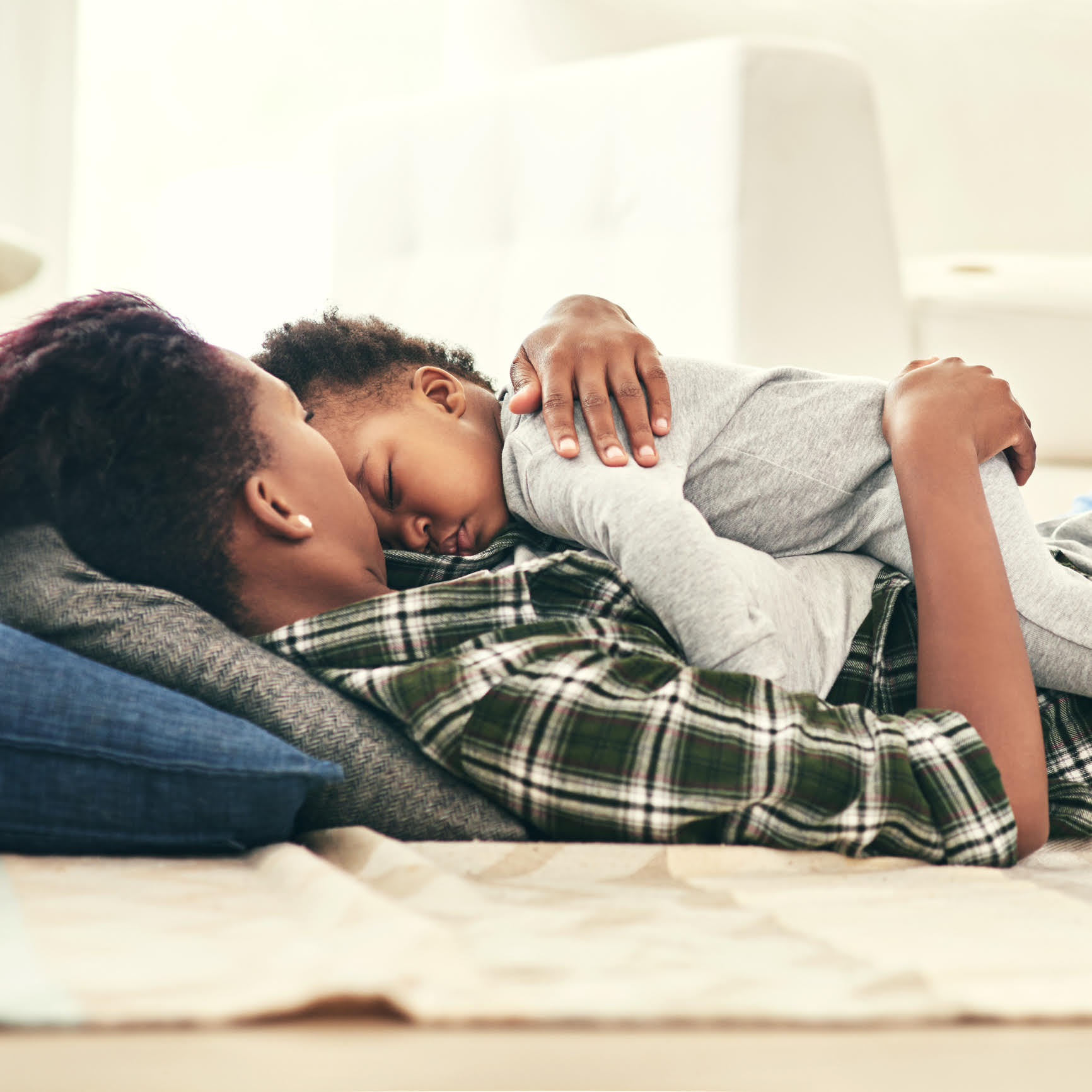 Shot of an adorable baby boy falling asleep in his mother’s arms